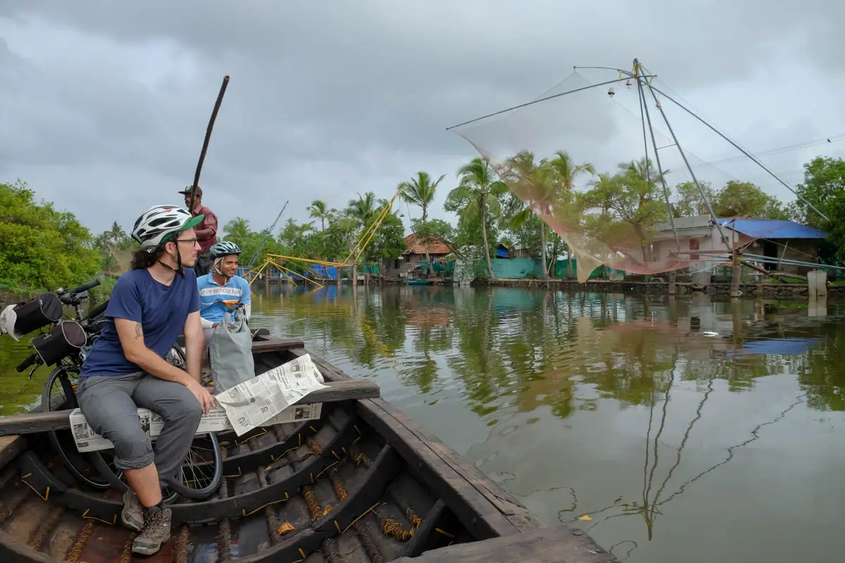 Riding in a traditional boat after a Kochi backwaters bicycle tour