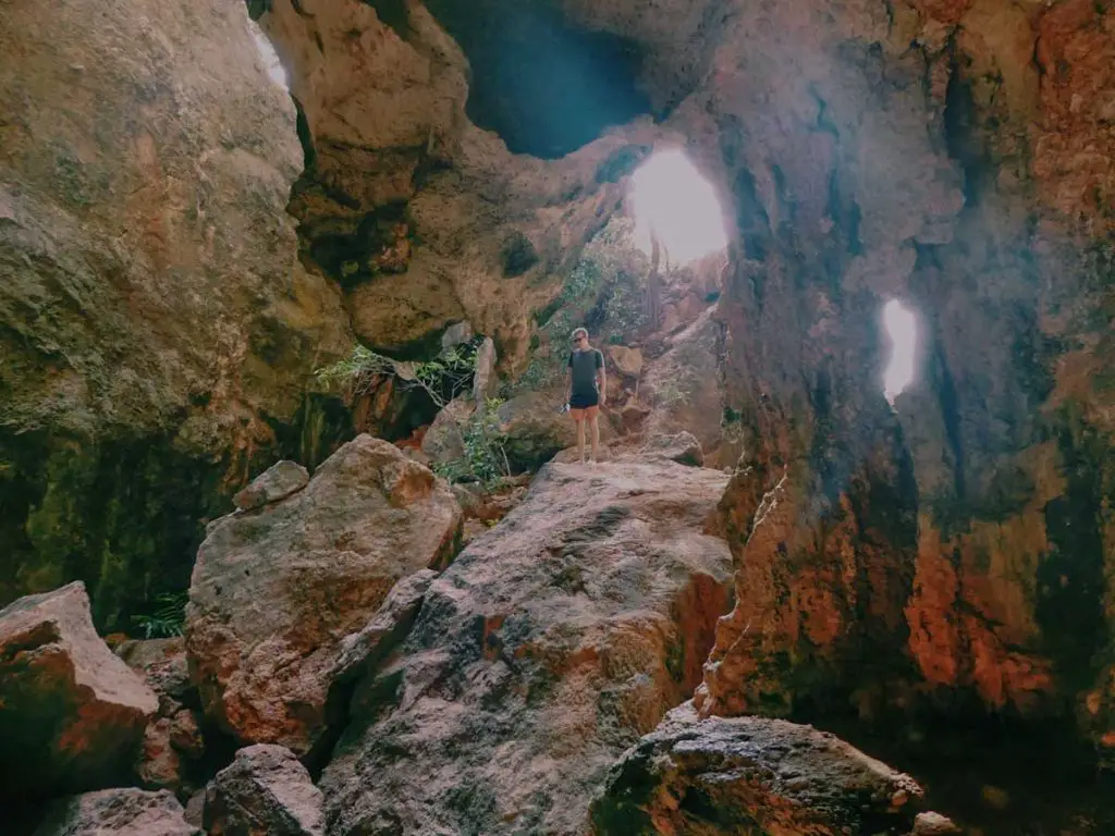 Photographing Thailand Krabi caves man standing on top of rock