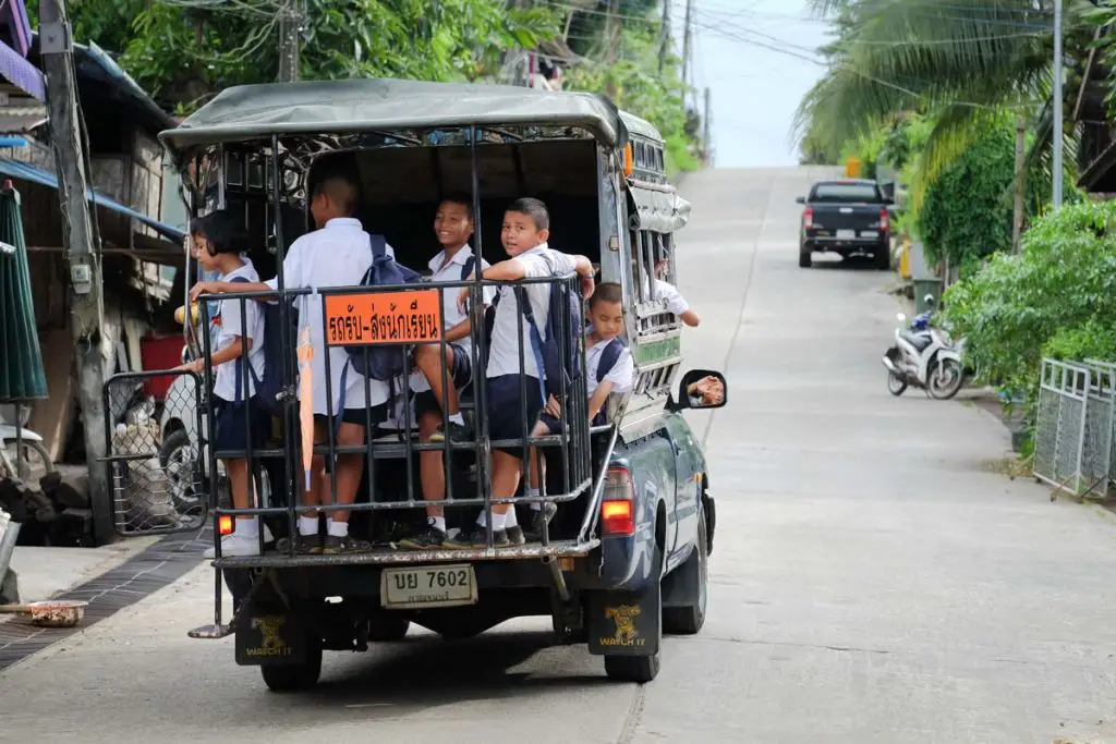 Thai children on a songthaew in Thailand. It's easy to photograph children in Thailand.
